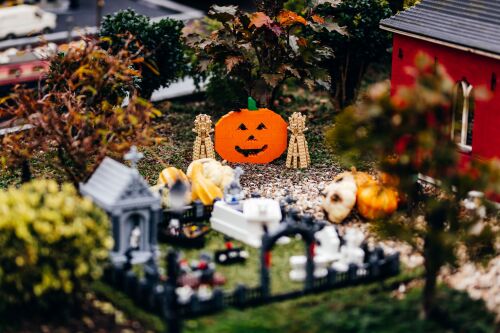 Besucher erleben auf der mit tausenden Kürbissen dekorierten Gruselstraße im LEGOLAND lustige Abenteuer und ziehen vorbei an freundlichen Gespenstern und klapprigen Skeletten.
